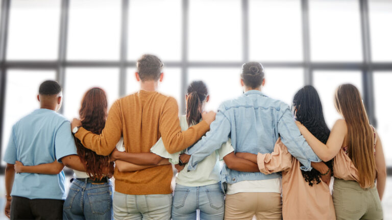 Friends standing together with arms linked