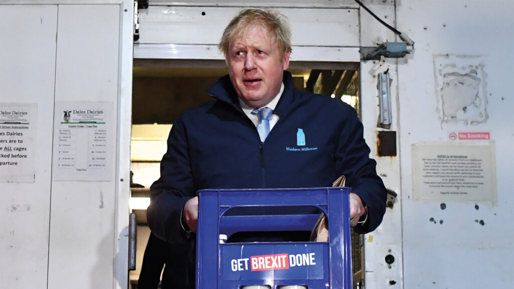 Boris Johnson carries a crate of milk to deliver to customers