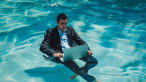 Business man in a suit floating on water