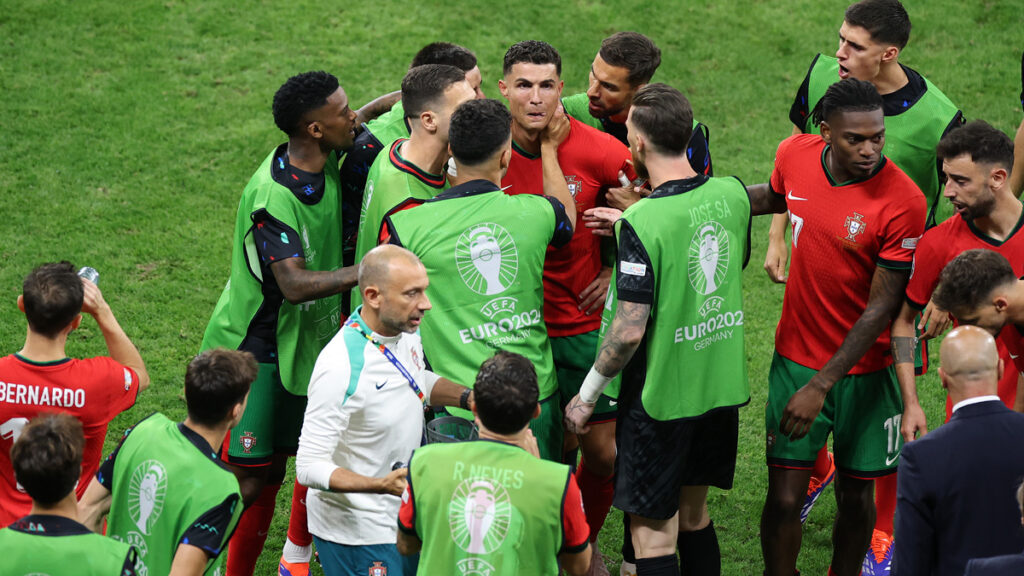 Cristiano Ronaldo is consoled by teammates at the end of the first half of extra time during the UEFA EURO 2024 round of 16