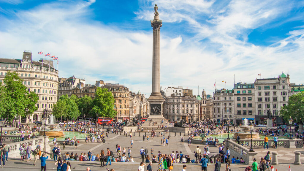 Trafalgar Square with Nelson Pillar and a crowd of people walking around