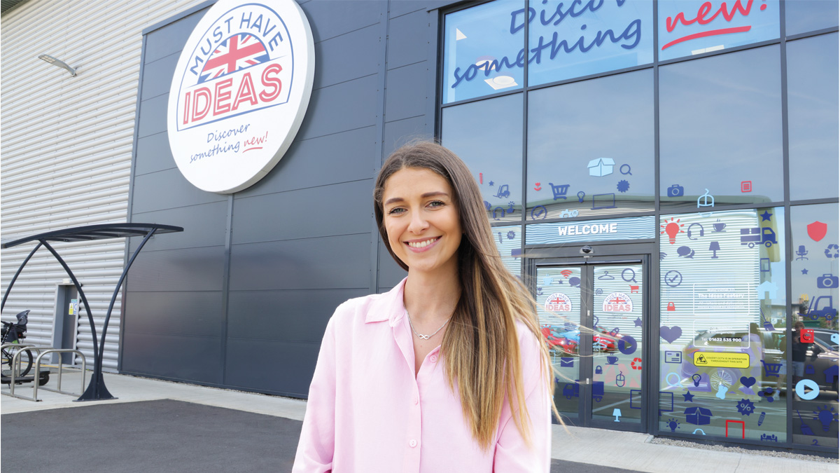 Amy Knight standing in front of Must Have Ideas' warehouse