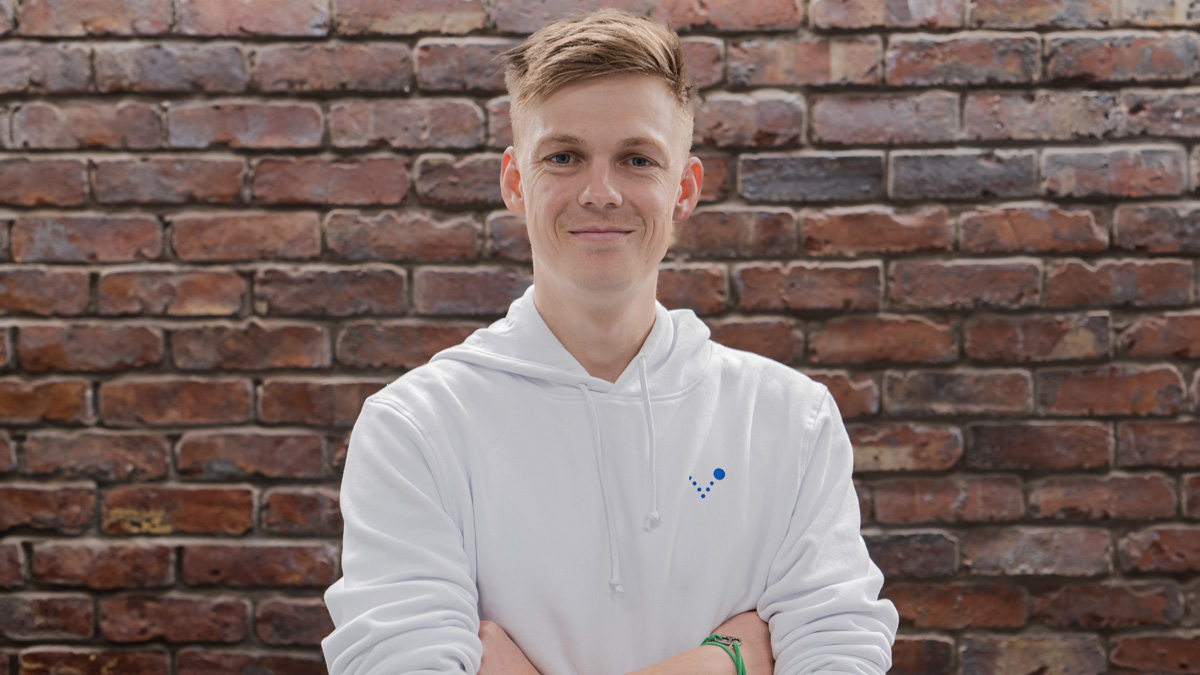 Caspar Lee standing in front of a brick wall