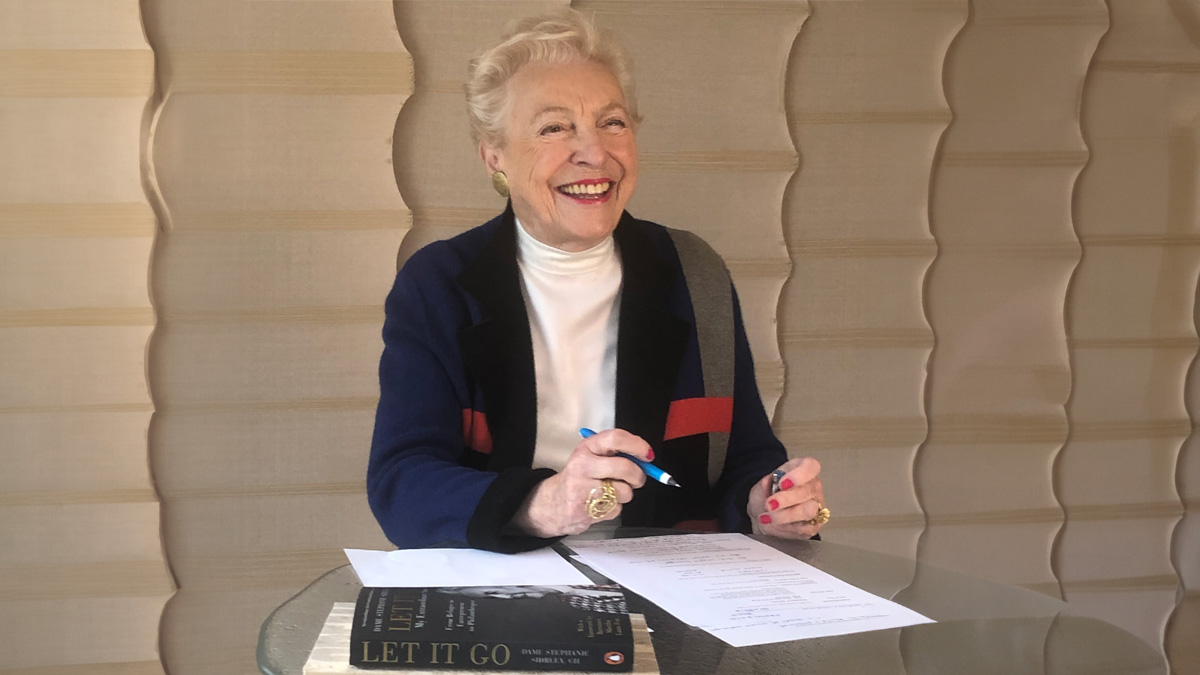 Dame Stephanie Shirley blue jumper with books