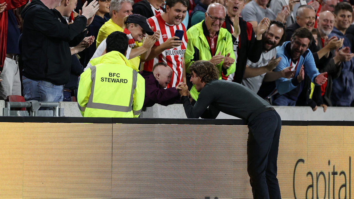 Thomas Frank, manager of Brentford celebrates with a fan after the Premier League match with Arsenal