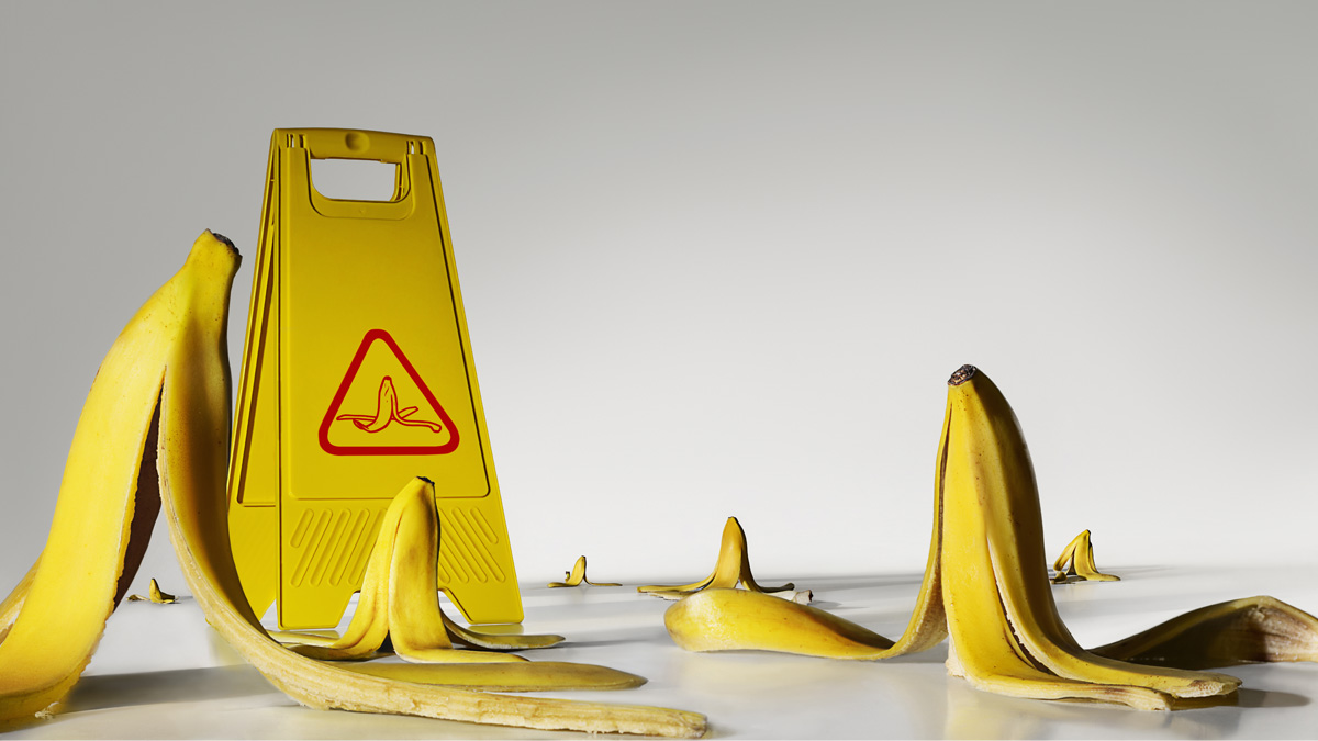 Banana peels on the floor with warning sign