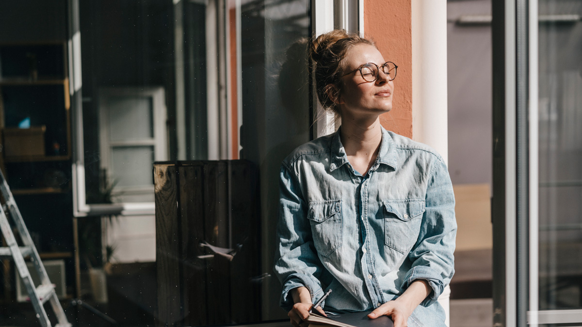 Young woman with glasses in sunlight