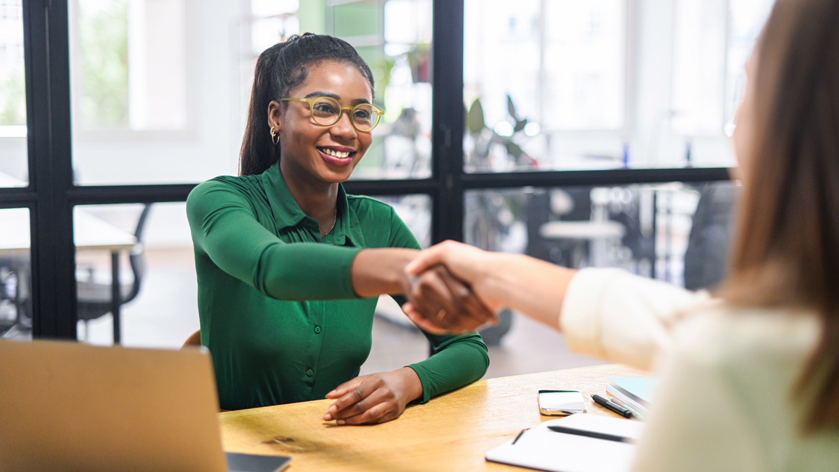 Business women shaking hands in the office during business meeting