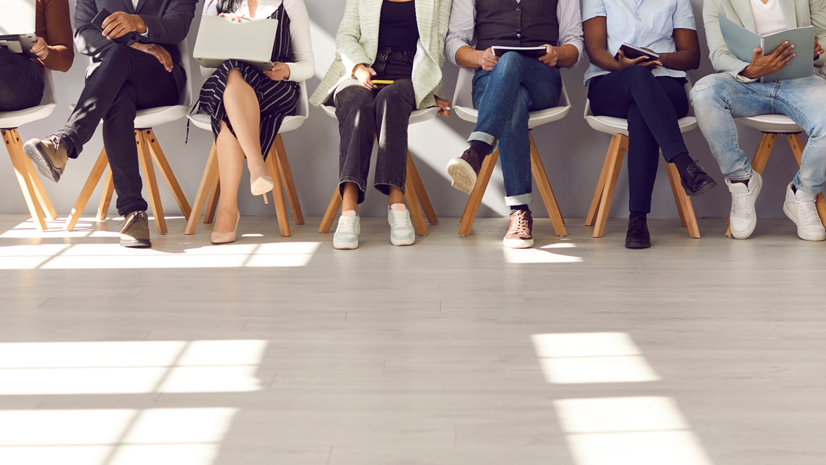 Diverse people waiting in line for appointment, job interview or work meeting