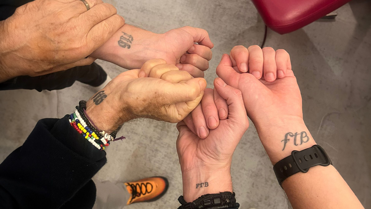 Eddie Jordan and his sons with Jake Humphrey showing their matching FTB wrist tattoos