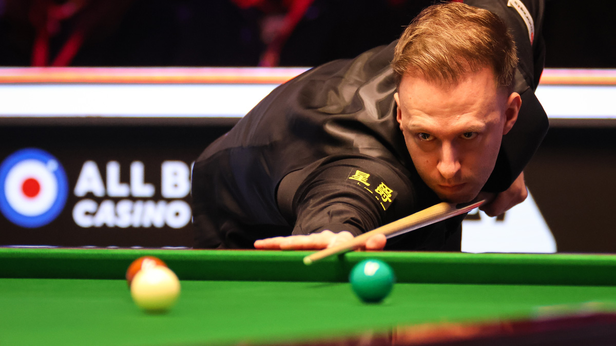 Judd Trump of England plays a shot in a match against Barry Hawkins in the 2024 UK Championship final