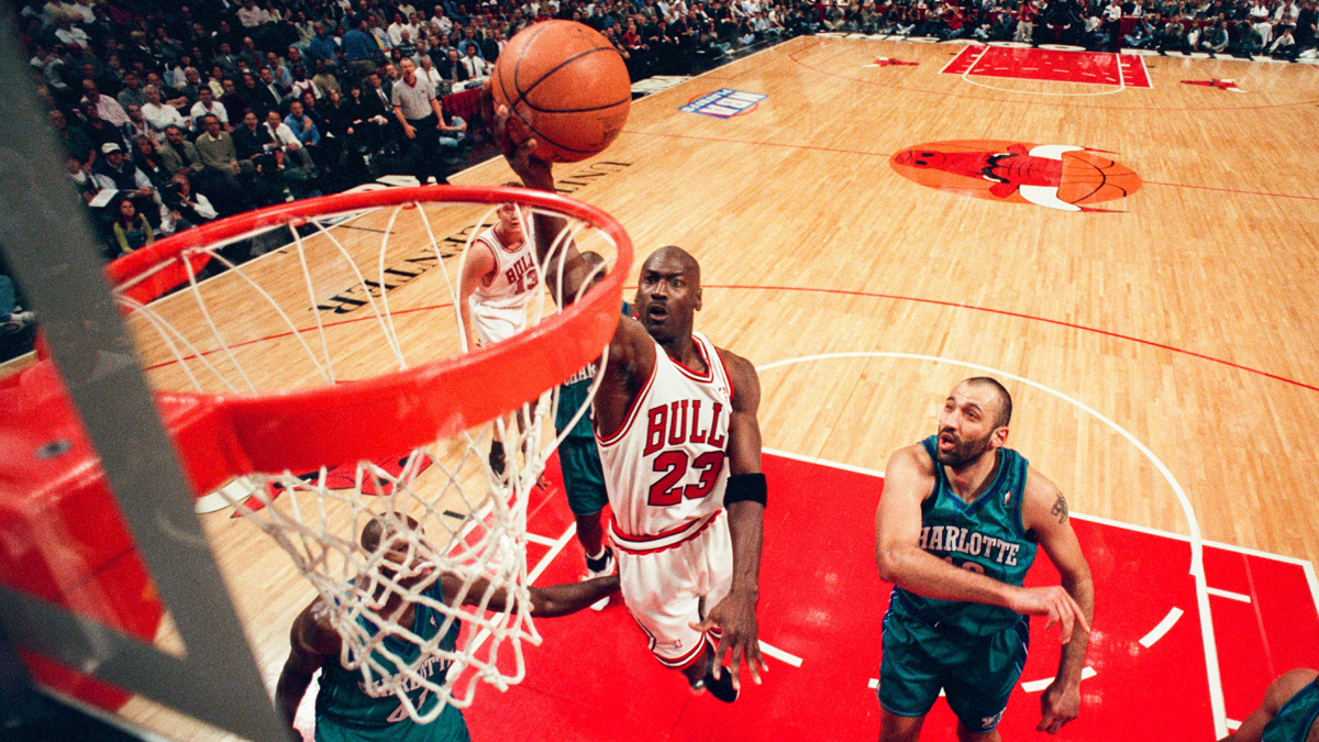 Michael Jordan of the Chicago Bulls takes the ball to the basket during the game against the Charlotte Hornets in 1998